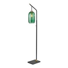 a black floor lamp with a green glass shade