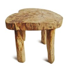 a small wooden stool made out of tree trunks on a white background with no one around it