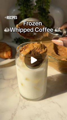 a person is scooping some ice cream into a glass with the words frozen whipped coffee on it