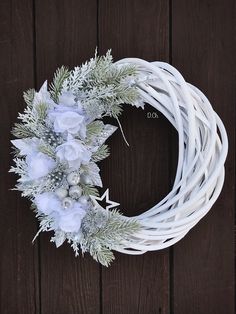 a wreath with white flowers and greenery