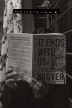 a woman reading a book in front of a window with the words friends with us written on it