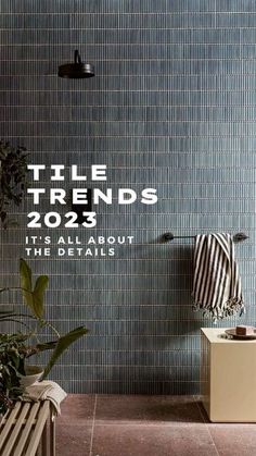 a bathroom with blue tile and plants in the corner, next to it is an advertisement for tiles