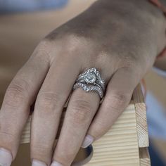 a woman's hand with a diamond ring on it