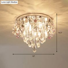 a chandelier hanging from the ceiling with measurements for it's length and width