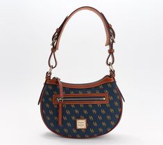 Take a trip down Dooney & Bourke memory lane with this crescent-shaped hobo, a redo of a 2007 classic. Just like the original, this smartly structured style hugs close to the body for dashes across town and effortlessly cool vibes. A thoughtful gift for Dooney forever fans and brand newbies alike. From Dooney & Bourke. Cool Vibes, Hobo Handbags, Metallic Logo, Memory Lane, Dooney Bourke, Fashion Handbags, Shopping List, Crescent, Thoughtful Gifts