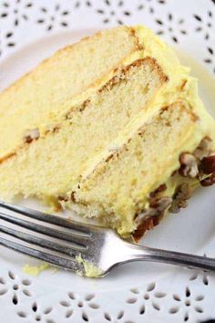 a piece of cake sitting on top of a white plate with a fork next to it