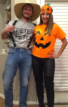 a man and woman dressed up as jack - o'- lantern and pumpkins