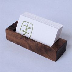 a business card holder made out of wood with chinese characters on the front and side