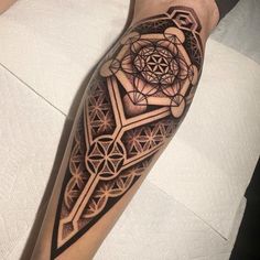 a man's arm with an intricate tattoo design on the forearm and leg,