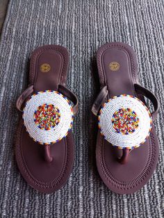 Unique Gift | Sandals | Gladiator Sandals | Greek Sandals | Beach Jewelry | Wedding Shoes | Leather Sandals | Custom | Mothers Gift An elegant and authentic pair of African inspired beaded ladies sandals, with a unique and eye-catching design. 100% genuine leather. Color - Multicolor.   *100%  Handmade.    S I Z E  C H A R T  EUUSAUKCMINCHES 343.51.522.38.8 354.52.5239 365323.69.3 376424.29.5 387524.99.8 398625.510 4096.526.110.3 4110726.810.6 4211827.510.8 4312928.211.1   ♥ you could also find White Beaded Sandals With Round Toe, Traditional Beaded Flip Flops With Round Toe, White Beaded Open Toe Sandals, African Print Shoes, African Sandals, Fancy Sandals, Beach Wedding Jewelry, Beaded Shoes, Handmade Sandals