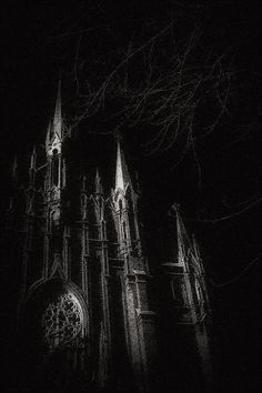 an old gothic church lit up at night