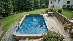 an above ground swimming pool in a backyard with steps leading up to the deck area