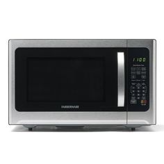 a silver microwave oven sitting on top of a white countertop with the door open