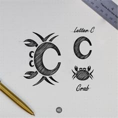 the letter c is drawn on top of a paper next to a pencil and ruler