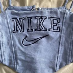 Nike Cropped Top. S/M White Lace Behind The Corset Top. Black And Blue Fitted Blue Top With Embroidered Logo, Nike Cropped Tops, Corset Nike Top, Nike Sporty Cropped Tops, Nike Corset Top, Nike Blue Top With Logo Print, Nike Corset, Corset Top Black, Nike Crop Top