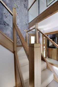 the stairs are made of wood and have glass balconies