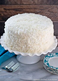 a close up of a cake on a plate with a fork and napkin next to it