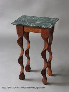 a small wooden table with marble top