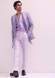 Elevate your evening ensemble with our expertly crafted three-piece tuxedo set. Crafted on a glamorous shimmer base. This lavender tuxedo is ornate with hand embroidered cutdana work and lapel detailing. Complemented with a pleated shirt and straight pants. This glitzy outfit will command everyone's attention. Dry-clean only if required. Slight variation in color is possible due to digital photography. Tailored Embellished Sets For Party, Elegant Formal Sets With Sequins, Elegant Formal Sequined Sets, Elegant Formal Sequin Sets, Luxury Fitted Evening Sets, Luxury Fitted Evening Set, Glamorous Tailored Wedding Suits, Designer Fitted Suits For Gala, Luxury Tailored Sets For Evening