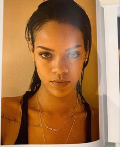 a close up of a person wearing a necklace with words on the front and back of her face