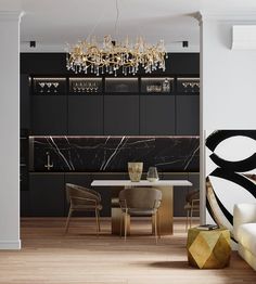 an elegant dining room with black and white decor, gold accents and chandelier