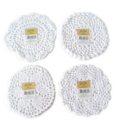 four white crocheted doily coasters with price tags