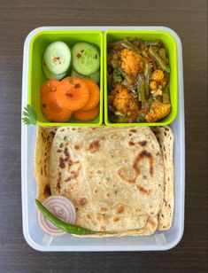 a plastic container filled with food on top of a wooden table