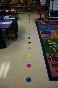 an empty classroom with colorful rugs on the floor