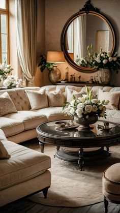 a living room filled with lots of furniture and flowers on top of a coffee table