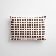 a brown and white pillow sitting on top of a table