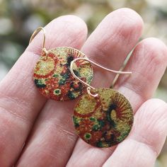 Groovy Bloom coin earrings with an etched and printed design of colorful blooms on a gold finish charm. They are lightweight and colorful with a textured surface with a subtle shimmer. Gold plated earwires. Earrings measure 1 1/4" from the top of the earwire. Find more great earrings here http://www.etsy.com/shop/everybeadofmyart?section_id=8084100 Thanks for shopping Every Bead of My Art! Handmade Copper Gold Flower Earrings, Handmade Gold Flower Earrings In Copper, Bohemian Flower Earrings As Gift, Hand Painted Copper Bohemian Earrings, Bohemian Hand Painted Copper Earrings, Bohemian Etched Copper Earrings, Bohemian Floral Print Flower Earrings As Gift, Bohemian Multicolor Floral Print Earrings, Bohemian Drop Earrings With Floral Print