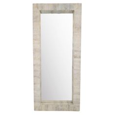 a white mirror sitting on top of a wooden frame