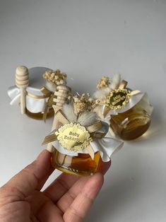 a hand holding a jar filled with honey