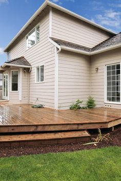 a large wooden deck in front of a house