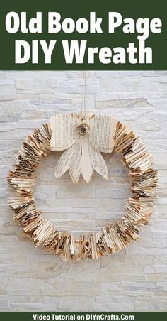 an old book page diy wreath hanging on a brick wall with text overlay