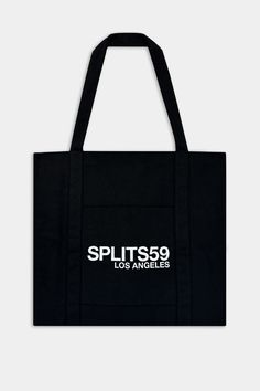 Front flat view of black tote bag with Splits59 Los Angeles white letter print Functional Black Bag With Logo Print, Functional Black Cotton Canvas Bag, Black Cotton Bags With Logo Print, Casual Black Canvas Bag With Letter Print, Functional Black Cotton Bag, Casual Black Bags With Logo Print, Black Letter Print Bag For Streetwear, Canvas Tote Bag For Streetwear, Trendy Black Bags With Logo Print