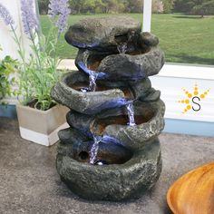 a stone water fountain sitting on top of a counter