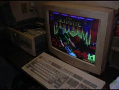 an old computer monitor sitting on top of a desk next to a keyboard and mouse