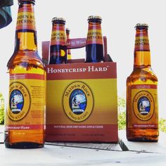 four bottles of honeycrisp hard beer sitting next to each other on a table