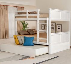 a white bunk bed sitting in the middle of a living room