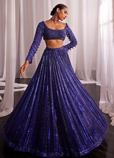 Elevate your style with this stunning Blue Crystal Linear Embroidered Georgette Lehenga Set, a perfect blend of tradition and modern elegance. Crafted from luxurious georgette , this blue lehenga features intricate hand embroidery adorned with shimmering sequins, cutdana, and crystal detailing that catch the light with every movement. Paired with a jewel-tone full sleeved blouse, adorned with delicate crystal embellishments, adds a regal touch to the look. Completed with a matching dupatta, embellished with the same intricate pattern, exuding sophistication. Perfect for brides or brides-to-be at Sangeet or Cocktail parties. Composition : Lehenga, Blouse - Georgette and Dupatta - Organza Care: Dry Clean Only and Vacuum Storage This product can be customized for sleeves, blouse length and ne Vani Vats, Georgette Lehenga, Crystal Embroidery, Blue Lehenga, Vacuum Storage, Embroidered Lehenga, Indian Wedding Wear, Lehenga Blouse, Sleeves Blouse