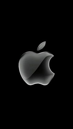 an apple logo on a black background with the light reflecting off it's side