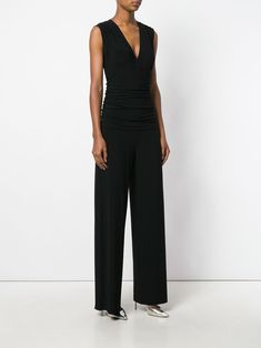 Black ruched plunge jumpsuit from Norma Kamali. Norma Kamali Dress, V Neck Jumpsuit, Jersey Jumpsuit, Latest Fashion Design, Crossbody Tote Bag, Cape Coat, Norma Kamali, Blazer Vest, Short Leggings