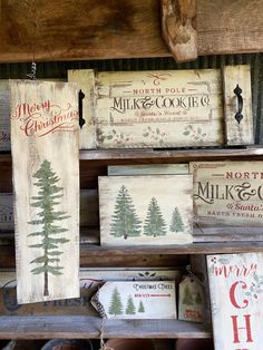 wooden signs are hanging on the wall in a store with christmas decorations and other items