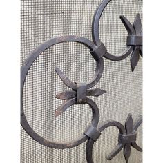 an iron fence with two circular designs on it