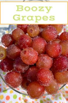 a glass bowl filled with frozen grapes on top of a polka dot cloth covered tablecloth