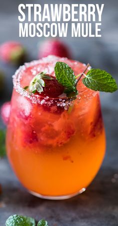 strawberry moscow mule cocktail with mint garnish on the rim and text overlay