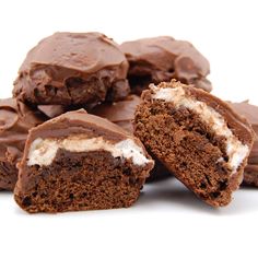 several pieces of chocolate cake with white frosting