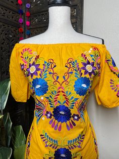 "Beautiful Floral Embroidered Dress - Handmade Embroidered Mexican Dress - Artisan Made Dress Beautiful hand embroidered dress! This has been made and brought directly from Puebla, Mexico. The dress has extremely detailed embroidery. The embroidery is 100% handcrafted. All the work on this dress has a professional skilled finish and the multicolor embroidered makes it look even more eye catching. The embroidery work is made with great quality thread. The eye catching will be on the embroidered w Traditional Dress With Multicolor Floral Embroidery, Summer Festival Floral Embroidered Fabric, Yellow Embroidered Dresses For Festive Occasions, Bohemian Floral Embroidered Fabric For Summer, Traditional Spring Embroidered Dress, Traditional Spring Embroidered Dress With Machine Embroidery, Traditional Fitted Dress With Geometric Embroidery, Fitted Traditional Dress With Geometric Embroidery, Traditional Multicolor Embroidered Dress For Spring