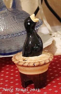 a black bird figurine sitting on top of a table